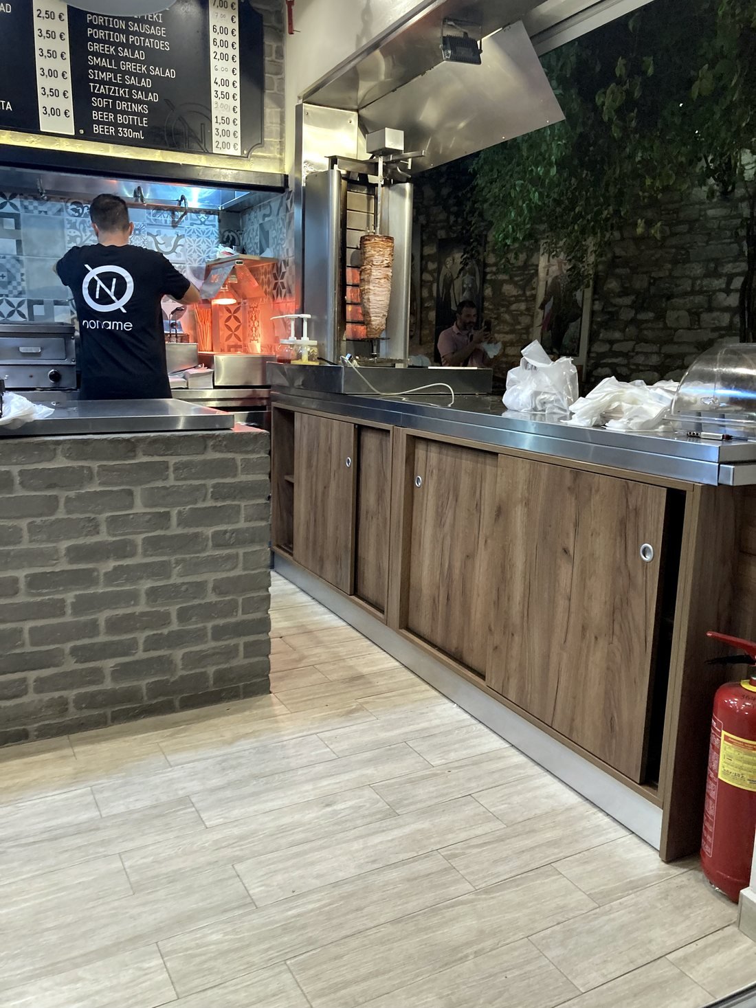 No Name counter with grill and black menu board