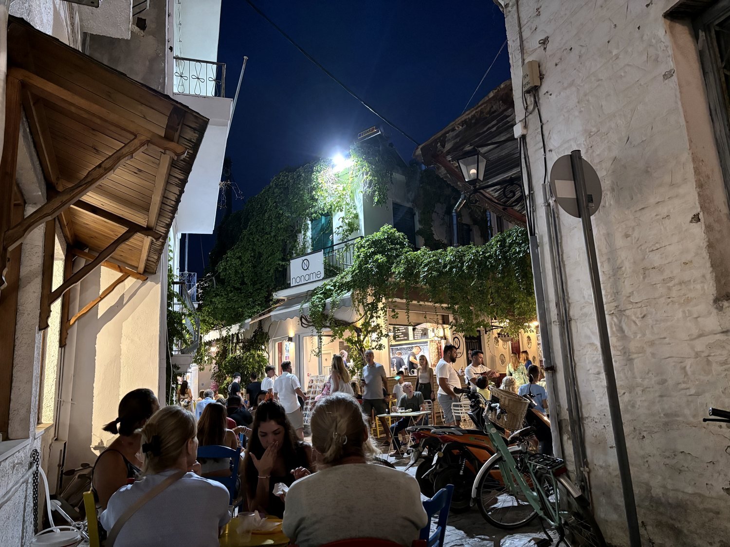 No Name Gyro Pita at night with people sitting outside in Skiathos Town